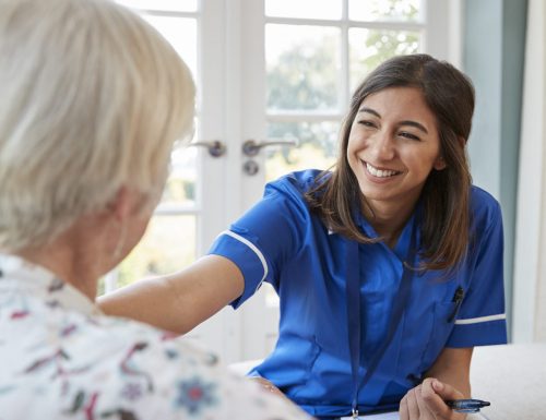 Young care nurse on home visit comforting senior woman Young care nurse on home visit comforting senior woman